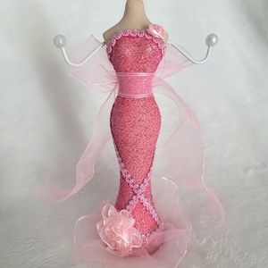 Jewelry standholder porcelain manican with detailed pink dress. Two arm prongs.